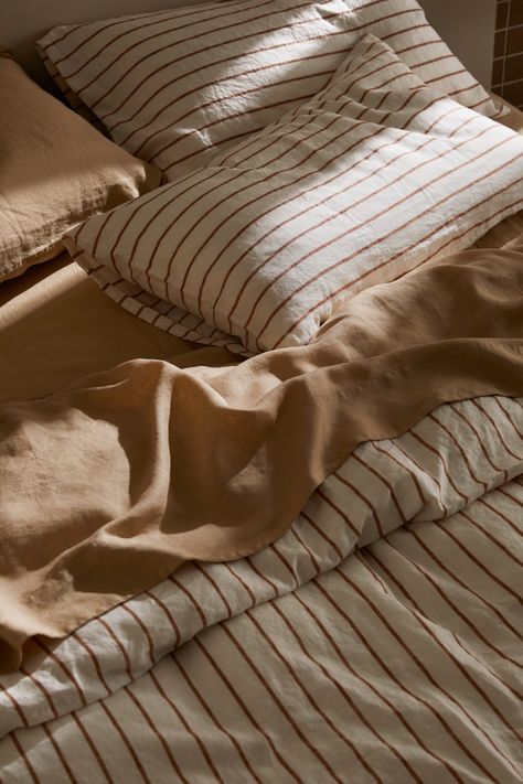 Express your style by mixing our 100% linen bedding colors. Crafted from European flax and pre-washed for unparalleled softness and durability, our collection offers a versatile palette of modern shades. Teracota Interior Bedroom, Bed Sheet Photography, European Pillows On Bed, Striped Sheets Bedroom, Bedroom Linens Bedding, Bed Linen Styling, Linen Sheets Bedroom, Bed Sheets Ideas Bedrooms, Caravan Styling