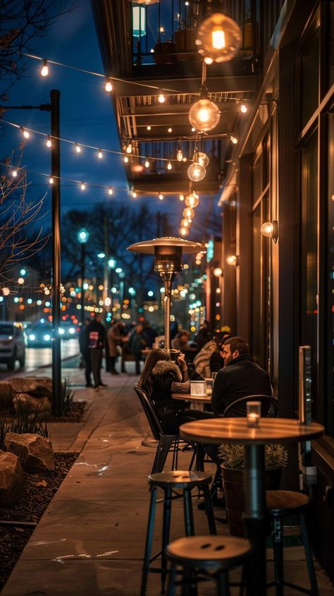 Evening Café Scene: Cozy evening at a bustling café with warm lights and patrons enjoying conversations under string lights. #evening #café #lights #urban #people #aiart #aiphoto #stockcake ⬇️ Download and 📝 Prompt 👉 https://ayr.app/l/F9n9 Coffee Shop At Night, Poetic Documentary, Cafe At Night, Warm String Lights, Coffee Shop Lighting, Cafe Idea, Street Coffee, Urban People, Italian Cafe