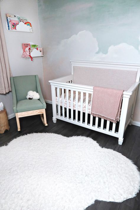 A gorgeous and calming cloud nursery. This sweet girl nursery has a beautiful hand painted sky mural and sweet bird art. #cloudnursery #girlnursery #MDBCstyle #girlnurseryinspo #nurseryinsipration #pinknursery #DarlingtonCrib Clouds For Nursery, Sky Mural Wall, Diy Cloud Mural, Cloud Mural Nursery, Clouds Nursery Theme, How To Paint Clouds On A Wall, Nursery Sky Theme, Baby Girl Nursery Mural, Sky Nursery Theme