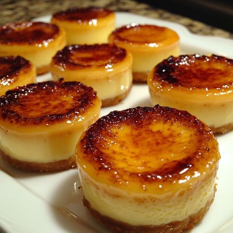 Mini Creme Brulee Cheesecakes Decadent Mini Creme Brulee Cheesecakes with Caramelized Sugar Topping Ingredients: 1 cup crushed graham crackers 1/4 cup melted butter 8 oz cream cheese, softened 1/2 cup granulated sugar 2 large eggs 1 tsp vanilla extract 1/2 cup heavy cream 1/4 cup milk 1/4 cup granulated sugar (for caramelizing) Directions: Preheat your oven to 325°F (163°C). Combine crushed graham crackers and melted butter. Press the mixture into the bottom of mini cheesecake pans. In a ... Mini Cream Brulee Cheesecake, Creme Burle, Cream Burlee, Mini Creme Brulee, Mini Cheesecake Pan, Creme Brulee Cheesecake, Raspberry Tarts, Rich Desserts, Caramelized Sugar