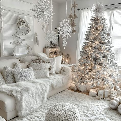 A white tree with silver ornaments and warm white lights sets the tone for a cozy indoor winter holiday. Perfect for creating a snowy look in your space. Silver Christmas Tree Ideas, White And Silver Christmas Tree, Silver Christmas Trees, Neutral Christmas Decor Ideas, White And Silver Christmas, Pinecone Centerpiece, Christmas Living Room Decor Ideas, Buffalo Plaid Table Runner, Christmas Living Room Decor