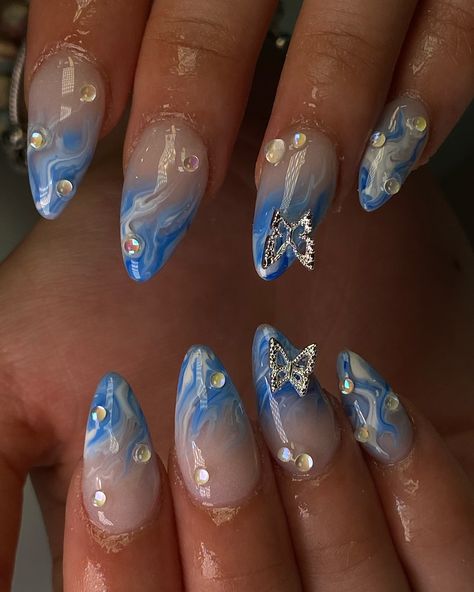 Summer blue marble 🦋💦🩵 Blue And Gold Nails Acrylic, Cruise Ship Nails, Blue Gel X Nails, Butterfly Nails Blue, Nails With Butterflies, Navy Blue Nail Designs, Cute Almond Nails, Almond Acrylic Nails Designs, Ocean Nails