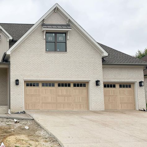 chi garage doors • Instagram 3 Car Garage Attached To House, Garage Doors On Brick House, Light Brown Garage Door, White House Tan Garage Door, Garage Door Farmhouse Style, C.h.i. Garage Doors, Brown Garage Doors Ideas, 3 Car Garage Exterior, Wood Look Garage Doors