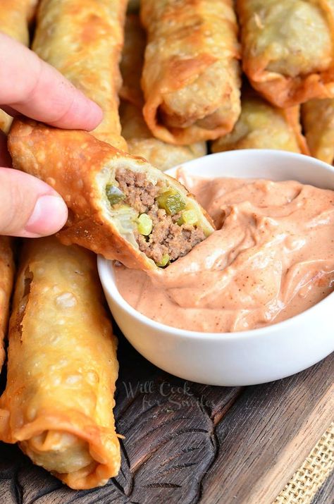 dipping cheeseburger Egg Roll into sauce that is in a small white bowl Cheeseburger Egg Rolls, Won Ton, Ground Beef Dishes, Egg Roll Recipes, Best Appetizer Recipes, Dinner With Ground Beef, Beef Dinner, Best Appetizers, Egg Rolls