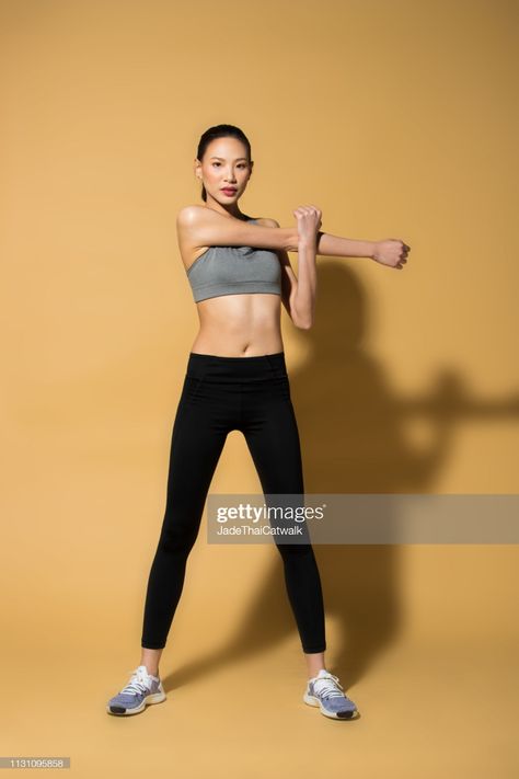 Stock Photo : Fitness woman exercise warm up stretch arms legs Arm Stretch Pose Reference, Grounded Photoshoot, Person Stretching Arms Reference, Arm Stretching Pose Reference, Arm Stretching Pose, Stretching Arms Pose Reference, Slim Legs Reference, Stretching Drawing Reference, Stretching Poses Reference