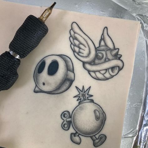 Shyguy Mario Tattoo, Mario Character Tattoos, Mario Theme Tattoo, Bobomb Mario Tattoo, Small Shading Tattoo Design, Stippling Shading Tattoo, Mario Kart Tattoo Ideas, Tattoo Stipple Shading, Traditional Mario Tattoo