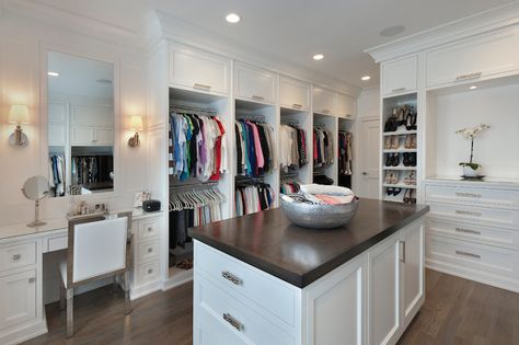 Fabulous walk-in closet features pull up cabinets stacked over double stacked clothes racks across beside a built-in dressing table paired with a white leather and chrome vanity chair under frameless vanity mirror illuminated by Thomas O'Brien Jonathan Sconces. Walk In Closet With Vanity, Closet With Vanity, Master Closet Layout, Small Master Closet, Master Closet Design, Master Closet Organization, Closet Vanity, Walking Closet, Walk In Closet Design