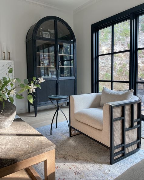 Living Room Black Accents, Cabinet Living Room Decor, Armoire In Living Room, Black Arched Cabinet, Lounge Chair Living Room, Cabinet Styling, Arched Cabinet, Black Lounge Chair, Living Room Cabinet