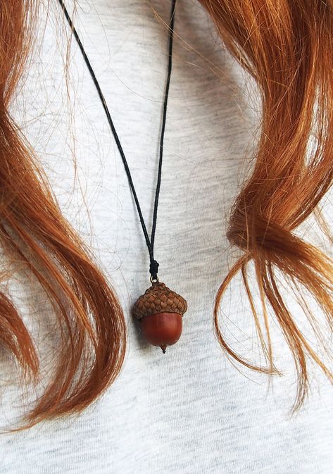 Pendant with natural acorn, which was picked right after it fall off of the oak tree. It was allowed to dry, cleaned and gently attached to the cap. It has a black thread chain to carry it on your neck. The thread is 40 cm length (if you want to get a longer thread, please let me know and I will add an extra length); The acorn size is approximately 2x2.5 cm / 0.78x0.98 inches (it can slightly vary). It comes in a gift ready packaging (recycled paper box). Keep in mind, that the pendant is not waterproof. Avoid direct contact with water (like swimming). Please, note that this is organic item. It can change its appearance and vary in color over the years. Due to varying monitor settings, the colors displayed on your screen might differ slightly from the real ones. Peter Pan Jewelry, Acorn Jewelry, Forest Necklace, Thread Chains, Acorn Pendant, Acorn Necklace, Black Thread, Oak Tree, Cute Crafts