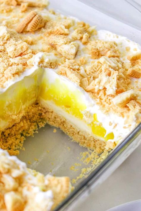 This Lemon Delight is a sweet, creamy no bake lemon dessert with layers of Golden Oreo, sweet cheese, lemon pudding, and whipped cream. Whether you call this recipe Lemon Delight or Lemon Lush, it's going to be a hit this summer! Lemon Dream Whip Cake, Heavenly Lemon Oreo Dessert, Lemon Pudding Cool Whip Dessert, Golden Oreo Cheesecake Delight, No Bake Lush Desserts, Four Layer Delight Recipe, Lemon Lush Dessert With Golden Oreos, Lemon Delight Dessert, Lemon Lush Cake