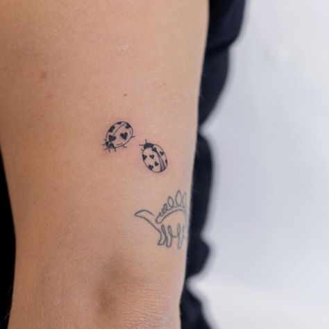 Tiny ladybugs tattoo on arm Simplistic Ladybug Tattoo, Tiny Tattoo Patchwork, Ladybug Neck Tattoo, Three Ladybugs Tattoo, Delicate Ladybug Tattoo, Ladybug Arm Tattoo, Heart Bug Tattoo, Two Ladybugs Tattoo, Tattoo Ideas Ladybug