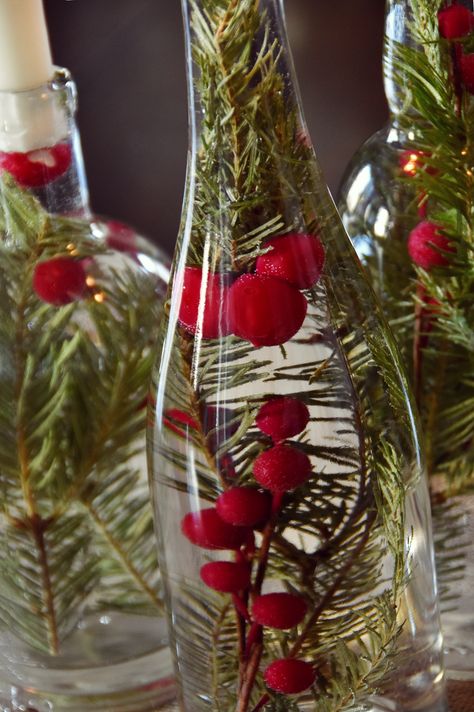 We're halfway through December, it's time to pick out a centerpiece! Try this super easy candle centerpiece that uses upcycled bottles and colorful berries. #[ Simple Candle Centerpieces, Glass Bottle Centerpieces, Upcycled Bottles, Xmas Centerpieces, Upcycled Christmas, Wine Bottle Centerpieces, Diy Gifts To Make, Bottle Centerpieces, Candle Centerpiece