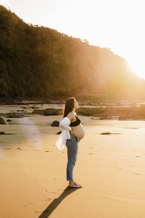 A gorgeous golden hour back lit image from a recent Sunset Maternity session in Raglan New Zealand. - Photographed by Hamilton New Zealand Maternity and Newborn Photographer Catherine Smith Photography Maternity Beach Photoshoot Jeans, Jeans And Shirt Maternity Shoot, Light Blue Maternity Dress Photoshoot, Maternity Photo Jeans And Shirt, Jeans Beach Maternity Shoot, Beach Sunset Maternity Photoshoot, Maternity Photography In Jeans, Maternity Photography Jeans And Shirt, Maternity Sunset Pictures