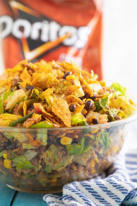 Doritos Taco Salad is loaded with seasoned ground beef, cheddar cheese, fresh vegetables, crushed Doritos, and tangy dressing. It's a perfect easy family dinner or a great potluck dish to pass that will always get rave reviews. Doritos Salad, Dorito Taco Salad, Snickers Caramel Apple Salad, Doritos Recipes, Salad With Cheese, Dorito Taco Salad Recipe, Dorito Taco, Deviled Egg Potato Salad, Taco Salad Doritos