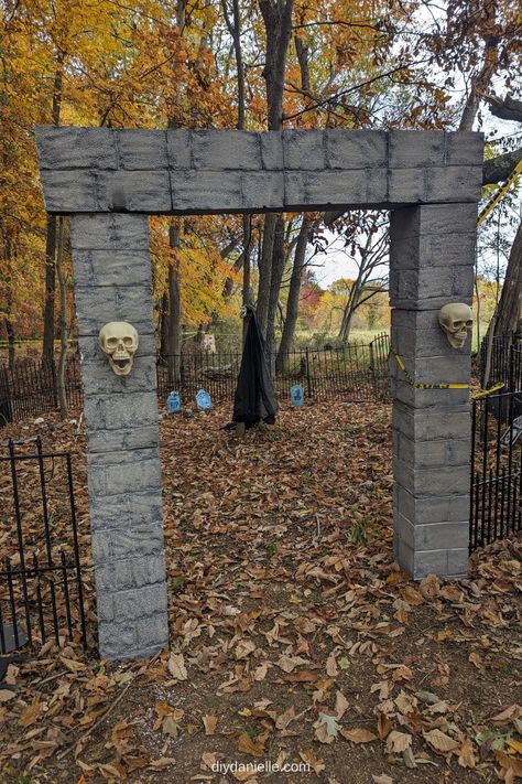 Here is the final picture of the cemetery entrance made of foam blocks and plastic skulls. Because I didn't have them mounted to the ground well (yet), I used caution tape and also fishing line to hold them in place next to the no dig dog fence that I'm reusing. Diy Graveyard, Diy Cemetery, Diy Halloween Graveyard, Cemetery Entrance, Halloween Fence, Cemetary Decorations, Easy Outdoor Halloween Decorations, Halloween Havoc, Spooky Graveyard