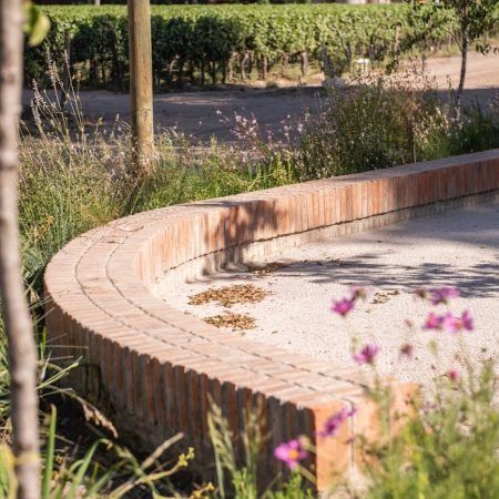 Cousiño Macul Winery Garden « Landezine International Landscape Award LILA Garden Sitting Wall, Brick Landscape Architecture, Brick Bench, Camping Projects, Bus Stop Design, Outdoor Vases, Water Playground, Garden Workshops, Urban Furniture