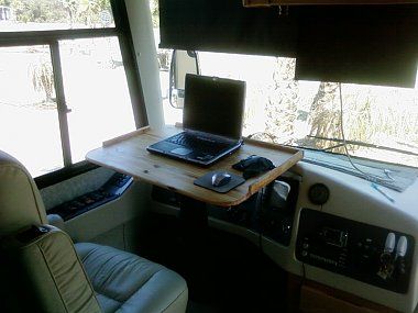 Custom steering wheel computer table.  Especially in a Class C, turning the cab into usable space would be a good idea.  We hang thermal curtains from the cabover bed to isolate the cab, so this would give a little privacy to one of the boys if they wanted to watch a movie or something. Imax Theater, Desk Station, Camper Mods, Bus Remodel, Monaco Style, Small Motorhomes, Homemade Camper, Fifth Wheel Trailers, Rv Makeover