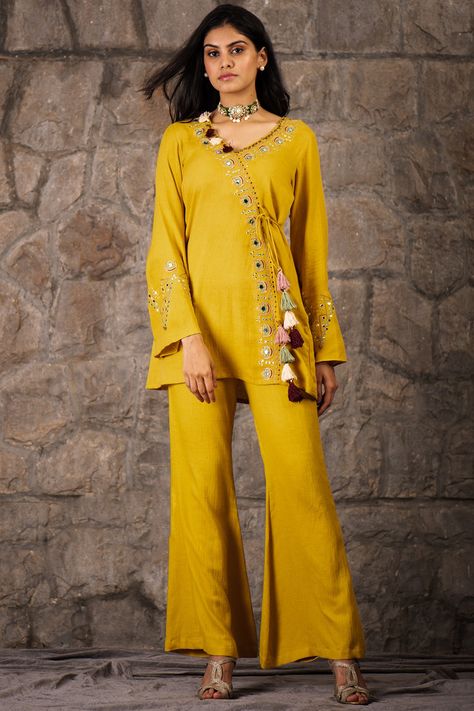 Featuring a mustard A-line top in cotton rayon and flex base with tassels, aari, and metal sequins embroidery. It is paired with matching bell-bottom pants.  FIT: Fitted at bust and waist.  COMPOSITION: Cotton rayon, Flex. CARE: Dry clean only. Co Ords Outfits, Salwar Pants, Cotton Kurti Designs, New Address, Blouse Hand Designs, Pants Fit, Top And Pants Set, Embroidered Neckline, V Neck Top