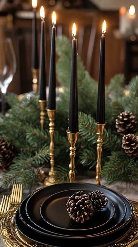 Festive table setting with black plates, gold cutlery, and a candelabra, surrounded by evergreen branches and pine cones. Christmas Details Aesthetic, Table Scape Christmas, New Years Table Setting, Christmas Table Aesthetic, Christmas Dining Table Decor Elegant, Black And Gold Christmas Table, Christmas Table Arrangements, Golden Cutlery, Luxe Christmas