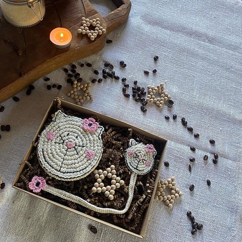 A nice little gift for cat lovers, book lovers and coffee or tea lovers. In the gift box there is a crocheted coaster and a bookmark. And since Christmas is coming, I added a Christmas ornament to the box. A small star made of wooden beads. What do you think? Do you like it? 🐈🐈‍⬛🐈. #catcoasters #catbookmark #booklovergift #handmadegiftbox #mrozcidesign #christmasgiftforcatlover #catlovergift #cozyvibes u Crocheted Coaster, Books And Coffee, Cat Christmas Gift, Cat Coasters, Gift For Book Lover, Crochet Coaster, Cat Books, Fabric Ornaments, Tea Lovers