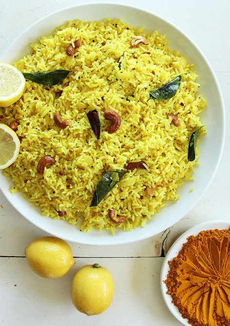 This lemon rice is a healthy dish for vegetarians. Adding gentle spices and cashews to plain rice heightens its nutritional value and digestibility. Eating lemon rice is sure to please your senses and warm your insides a little. #lemon #rice #indianrecipe #indiandish #southIndian #dinnerside via @https://www.pinterest.com/butteredveg/ Rice With Cashews, Rice Turmeric, Regional Recipes, Buttered Cabbage, Indian Thali, Cultural Food, Plain Rice, Iranian Cuisine, Delicious Sides