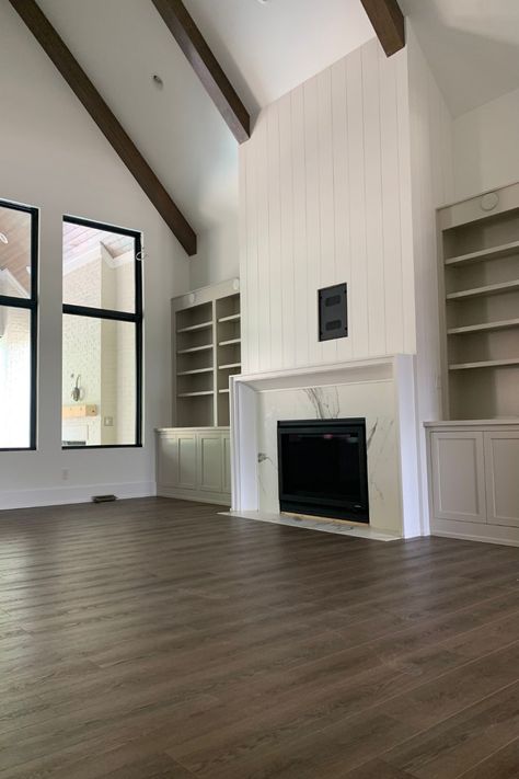 The beams. The vertical shiplap. The built-ins. It's all just too much! Bold prediction: We foresee vertical shiplap becoming more popular this year. What do you think? Vaulted Ceiling Shiplap, Shiplap Great Room, Vertical Shiplap Over Fireplace, Fireplace With Vertical Shiplap, Vertical Shiplap On Fireplace, Fireplace Vertical Shiplap, Vertical Wide Shiplap Wall, Vertical Shiplap Fireplace Wall, Shiplap Fireplace Tall Wall