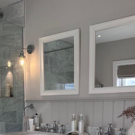 Chloe Dulieu on Instagram: "The master en-suite 🫶🏼

Vanity unit- @burlingtonbathroom 
Taps- @burlingtonbathroom 
Mirrors- @drench.co.uk 
Floor tiles- @mandarinstoneofficial 
Wall tiles- @toppstiles 
Wall lights- @lighting_direct 
Walls painted in Ammonite, panelling painted in Cornforth White @farrowandball 

#bathroominspo #masterensuite #ensuite #bathroom #doublevanity #vanityunit #carraramarble #shaker #woodeffecttiles #bathroomtiles #neutralbathroom #neutrals #renovation #countrymodern #calming #relaxing" Ammonite Panelling, Cornforth White, Neutral Bathroom, Master Ensuite, Wood Effect Tiles, Ensuite Bathroom, Painted Paneling, Direct Lighting, Bathroom Inspo