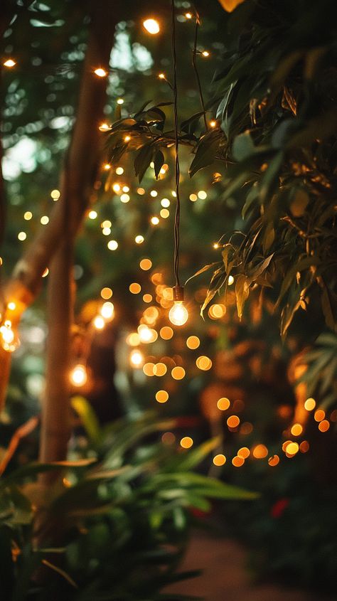 A romantic evening wedding under twinkling fairy lights, a bride in a satin gown and groom in a sleek suit, surrounded by lush greenery, captured with soft bokeh and warm tones. (Canon EOS R5, 50mm f/1.2) Wedding In Spain, Barcelona Wedding, Wedding Spain, Love Film, Wedding Videographer, Wedding Videography, Lush Greenery, Wedding Film, Wedding Video