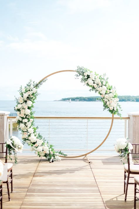 Circle arbor with white flowers for outdoor Beauport Hotel wedding on the water in Gloucester, MA. Photography by Sarah Surette. Wedding Arbour White Flowers, Wedding Arch Round Flowers, Circle Arbor Wedding Flowers, White Flower Wedding Decoration, Circle Arch Wedding Flowers, Circular Arbor Wedding, Circle Alter Wedding, Round Wedding Arbor, Circle Arbor Wedding