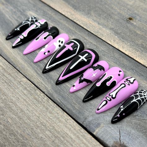 Dawn Witch Designs Unique, re-usable, hand painted, and made in Canada. These luxury press on nails are handmade using high quality gel polish and salon-grade materials.  ✨ PASTEL CREEP ✨  This pastel-goth Halloween set features adorable hand-drawn art in pink, black, and white. The images on one hand compliment the ones on the other with mirrored colours. This makes for a visually sumptuous set that will be a guaranteed conversation-starter! Due to the number of images and details on each nail, Goth Nails Halloween, Goth Pastel Nails, Pastel Goth Nails Short, Hot Pink And Black Halloween Nails, Planchette Nails, Pastel Witch Nails, Girly Goth Nails, Pink Black Halloween Nails, Black Nails With Pink Design