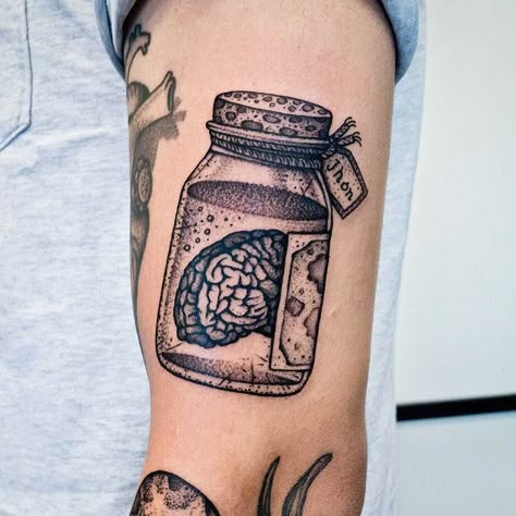 Brain in a jar tattoo inked on the left arm Mh Tattoo, Brain In A Jar, Psychology Tattoo, Jar Tattoo, Patch Work Tattoo, Rip Tattoos For Mom, Anatomy Tattoo, Feminine Skull Tattoos, Places To Get Tattoos