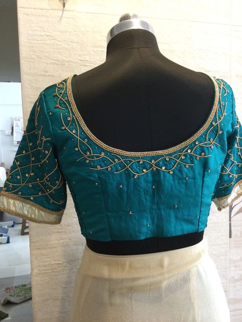 "Teal Treasure: Dive into the elegance of this teal blue blouse, adorned with golden beadwork for a touch of timeless glamour. 💙✨ #TealElegance #GoldenBeadMagic" Teal Blue Blouse Designs, Teal Green Blouse, Teal Blue Blouse, Blue Blouse Designs, Timeless Glamour, Copper Design, Green Blouse, Blue Blouse, Teal Green