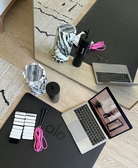 A laptop is sitting on a yoga mat surrounded by other various workout equipment. Working Out From Home Aesthetic, Yoga Asethic, Home Workout Asethic, Workout Astetics Wallpaper, Ankle Weights Aesthetic, Exercise Astethic, Fitness Asethic Girl, Sportive Girl Aesthetic, Business Asethic