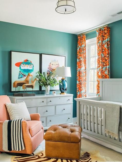 Blue and orange nursery features walls painted blue, Sherwin Williams Riverway, lined with a light gray crib, Bassett Chesapeake Full Panel Crib, dressed in white and gray crib bedding flanked by windows dressed in orange and turquoise blue curtains, DwellStudio Vintage Plumes Fabric. Neutral Nursery Colors, Neutral Kids Bedroom, Nursery Inspiration Boy, Orange Nursery, Gender Neutral Kids Room, Eclectic Nursery, Neutral Kids Room, Nursery Pictures, Adorable Nursery