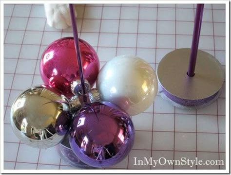 How to make a table top Christmas tree using a round ball ornaments and a knitting needle. When the holidays are over, it easily comes apart so you can store it with ornaments. #ChristmasDecorDIY #ChristmasOrnaments #ShinyBrites ##ChristmasTrees #EasyChristmasDecorations Christmas Balls Decorations, Christmas Tree Decorations Diy, Christmas Tabletop, Lace Doily, Easy Christmas Decorations, Christmas Projects Diy, Knitting Needle, Christmas Ornament Crafts, Christmas Centerpieces