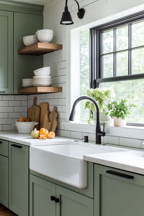 Discover the latest kitchen design trend with this modern farmhouse look! Featuring stylish green cabinetry, open shelving, and a deep farmhouse sink, this space combines functionality and elegance. Perfect for any home makeover! #kitchendesign #farmhousechic #homedecor Green Cabinetry Kitchen, Green Farmhouse Cabinets, Green Kitchen Floating Shelves, Green Kitchen Black Sink, Farmhouse Sink Green Cabinets, Green Kitchen Butcher Block, Farmhouse Kitchen Green Cabinets, Green Farm Kitchen, Sage Green Kitchen Decor