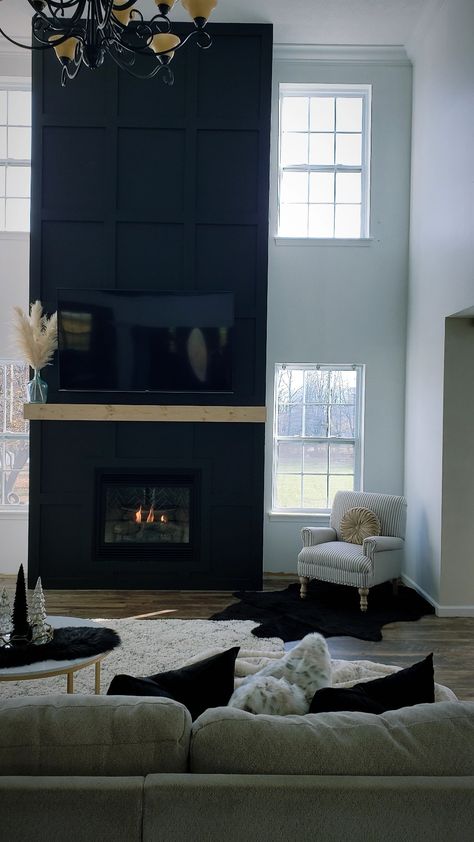 Black Fireplace High Ceiling, Blacked Out Fireplace, Tall Fireplace Wall High Ceilings Black, Black Electric Fireplace Living Room, Black High Ceiling Living Room, Very Tall Fireplace Wall, Black Wainscoting Fireplace Wall, Modern Black Tile Fireplace Wall, Black Surround Fireplace