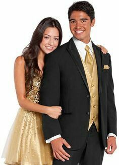 Couple wearing Black and Gold  ensemble Black Tux With Gold Accents, Gold Tux, White Jeans For Men, Chambelanes Outfits, White Tuxedo Wedding, Prom Tux, Gold Tuxedo, Tuxedo Prom, Groom Tux