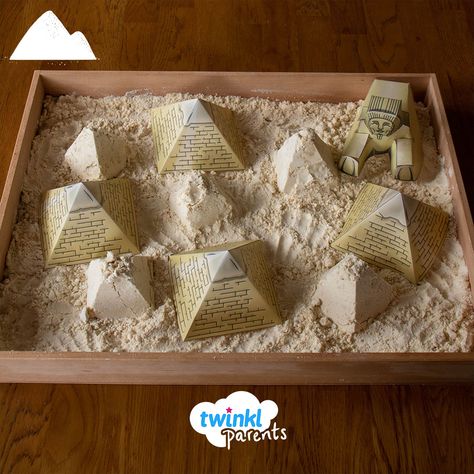 Why not learn about Ancient Egypt by creating your very own small world? This play tray was very quick and simple to do. Create some moulding sand using our recipe from the Twinkl website.   Challenge your children to make some pyramids using the sand- they could use a pyramid-shaped mould or maybe encourage them to sculpt the shapes themselves. Great Pyramid Of Giza School Project, Pyramid Activities For Kids, Science Sensory Activities Preschool, Ancient Egypt Activities For Kids, Ancient Egypt Decorations, Pyramid Project Ideas, Ancient Egypt Display, Egypt Display, Egypt Decorations