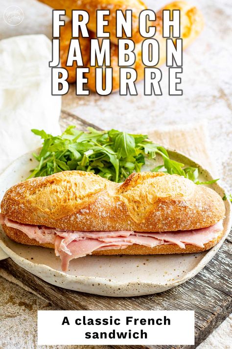 The Jambon beurre is a classic French sandwich testament to French cuisine's beauty. It's simple and delicious. Jambon beurre is a three-ingredient sandwich that you'll find at most boulangeries (French bakeries). But don't be fooled by its simplicity; the key to a perfect jambon beurre is in the quality of the ingredients. You want a fresh, crispy baguette, a good quality ham, and the best butter you can find. It's incredible how the simplest things often turn out to be the best. French Ham And Butter Sandwich, French Ham And Cheese Baguette, French Sandwich Baguette, Ham And Butter Sandwich, French Sandwich Recipes, French Sandwich, Baguette Sandwich, Bacon Sandwich, Ham Sandwiches