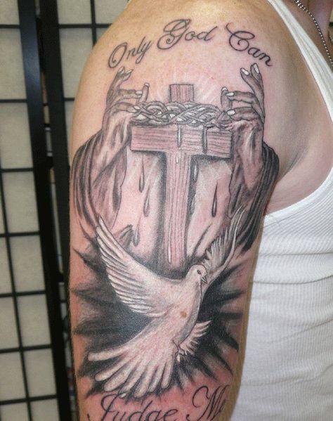 This is an interesting tattoo with a dove in it. The tattoo has a wooden cross with intertwining vines placed just above the intersection of the cross. The tattoo also has a pair of hands with each hand beside each end of the cross to appear like they are holding it. A dove is just below the cross. The words, only God can, are placed above the cross and the words, judge me, are placed below the dove. Dove Tattoo Meaning, Peace Dove Tattoos, Cross With Dove, Dove Tattoo Design, Dove Tattoos, Small Bird Tattoo, Dove Tattoo, Kunst Tattoos, Cross Tattoos