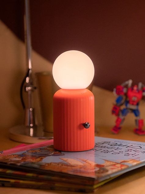 Versatile lighting! ✨ A totally unique design that takes inspiration from Lund's iconic Skittle bottle! The silicone bulb has 8 color settings and it's wireless so can easily be used anywhere. With a wireless phone charger included, this is the perfect bedside duo. Wireless. Charge the lamp with a wireless charger or color-changing bulbs with a micro USB cable. Dimmer switch to adjust brightness. Silicone nonslip base. Wireless phone charger included. Up to 14 hours of battery life from a single Cool Unique Lamps, Counter Lamp Kitchen, Mid Century Modern Table Lamp, Blender Inspiration, Wireless Lamp, Fun Lamp, Eclectic Lamps, Wireless Lighting, Nightstand Lamps