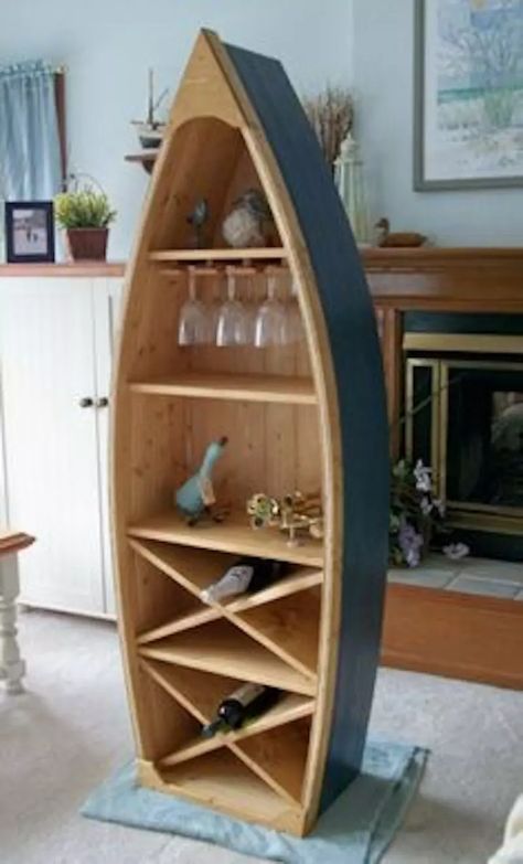 6 Home Decor Ideas To Repurpose Your Old Canoe - Paddling Magazine Canoe Shelf, Pine Bookshelf, Canoe Paddle Decor, Boat Bookcase, Wine Rack Glass Holder, Boat Shelf, Paddle Decor, Bookshelf Chair, Nautical Furniture