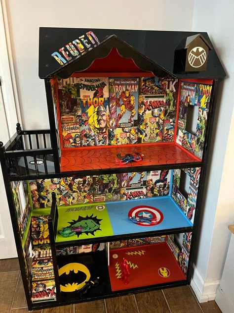 Black dolls house with superhero theme inside include Ironman, captain America, the hulk and Batman Toddler Boys Room Marvel, Avenger Doll House, Marvel Playroom Ideas, Superhero House Diy, Superhero Playroom Ideas, Marvel Toy Storage, Diy Superhero Bedroom, Diy Superhero House, Superhero Themed Room