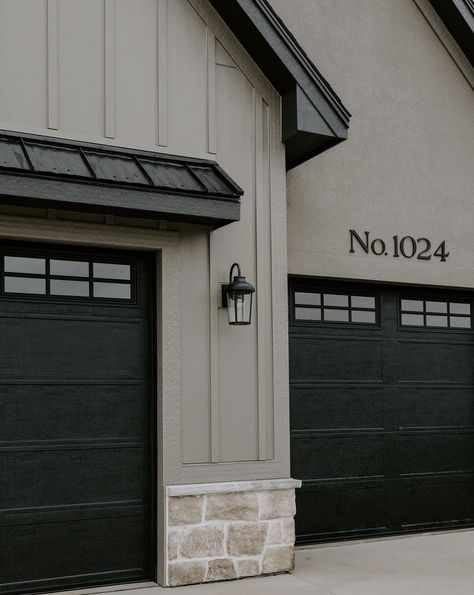 Black House Black Garage Door, Black Garage Door Gray House, Taupe And Black Home Exterior, Black Brick House Exterior Color Combos, Round Stone Exterior Houses, White Exterior Black Garage Door, Exteriors With White Windows, Beige House Black Trim Exterior, Cream Modern Farmhouse Exterior