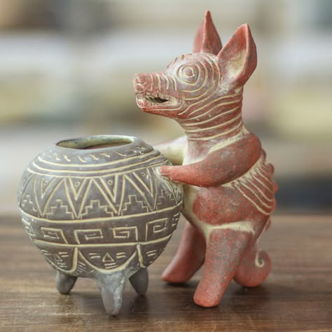 This fabulous ceramic figurine captures the essence of the revered tlalchichi dogs, once cherished companions during Pre-Hispanic times in the Mexican state of Colima. With a vase held gracefully in its paws, this extraordinary decorative accent showcases a blend of brown and grey hues with an exquisite aged antique finish. Experience the rich history and artistry of Mexico with this stunning treasure handcrafted by the members of the Angel Ceron Artisan Association. Aztec Ceramics, Mexican Vases, Prehistoric Pottery, Instrument Design, Ancient Mexico, Mayan Art, American Ceramics, Mexican Ceramics, Angel Sculpture