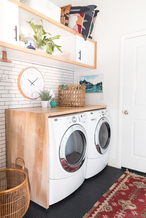 Budget Laundry Room Makeover Reveal!  Love the white subway tile and black penny tile floors!! Wood Laundry Shelf, Laundry Room With High Washer And Dryer, Laundry Room Washer Dryer Shelf, Wood Top Washer And Dryer, Diy Built In Washer And Dryer, Shelf On Washer And Dryer, Wood On Top Of Washer And Dryer, Shelf On Top Of Washer And Dryer, Wood Shelf Over Washer And Dryer