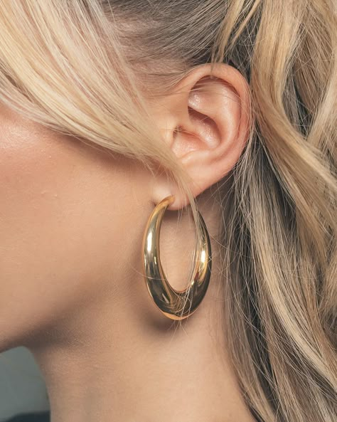 Turn heads no matter where you are! These sleek open hoop earrings are sure to add shine to all of your favorite looks. Available in gold and silver tones. Materials: 14K gold or rhodium plated brass Features: 2.1" hoop, 0.2-0.5" thickness, Lead & Nickel free, post back Gold Plate Earrings, 60s Hoop Earrings, Classy Hoop Earrings, Gold Hoop Earrings Chunky, Large Hoop Earrings Aesthetic, Gold Oval Hoop Earrings, Earrings Gold Stack, Gold Loop Earrings, Hold Hoops Earrings