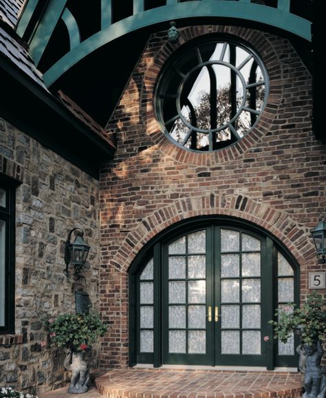 Talk about making a first impression. The arch-top swinging french doors, the round window, the wood accent... perfection. Interesting Windows, Marvin Doors, Arched French Doors, Entrance Wood Door, Circular Window, Arched Front Door, Round Windows, Marvin Windows And Doors, Garage Door Types