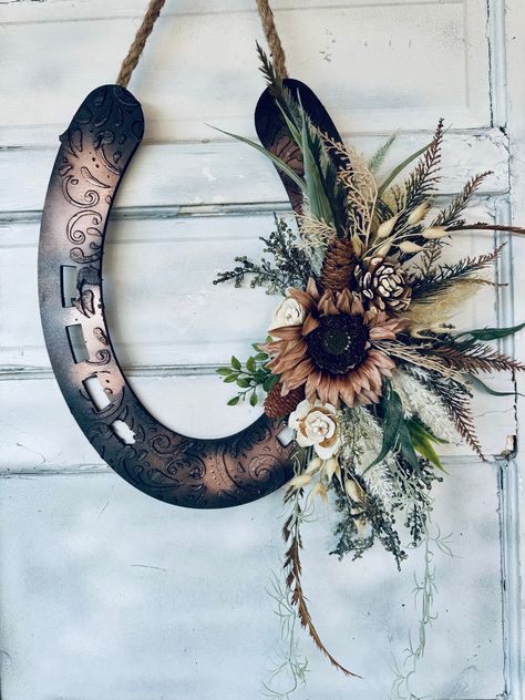 Multi media equestrian art for your home or doorway with different layers of embellishments that add unique beauty and sophistication.  Made for horse lovers in Mind!  LeAther Patterned good Luck Wreath that is both Rustic and Beautiful. Rustic Look with a contemporary  floral spray.  Makes a great Housewarming gift or even a memorial Wreath. I offer many different decorated versions of wood horse heads from fall to spring/summer to Christmas. Message me for links. :-) NEED CUSTOM COLORS? Just a Decorating With Horse Shoes, Rustic Western Christmas Decor, Horse Shoe Decor Ideas, Wagon Wheel Decor Indoor, Diy Rustic Decor Ideas, Horse Shoe Decor, Horseshoes Crafts, Rustic Cowboy Decor, Deer Antler Wreath